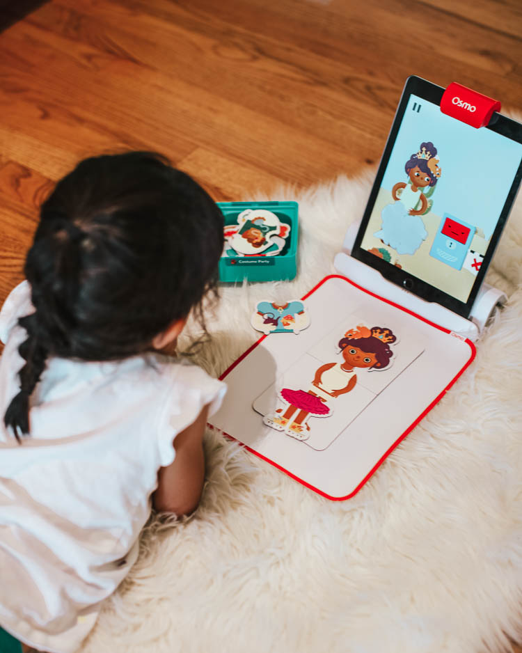 cute & little | stem education learning at home | osmo coding costume stories review | Stem Games by popular Dallas lifestyle blog, Cute and Little: image of a little girl doing Osmo stories. 