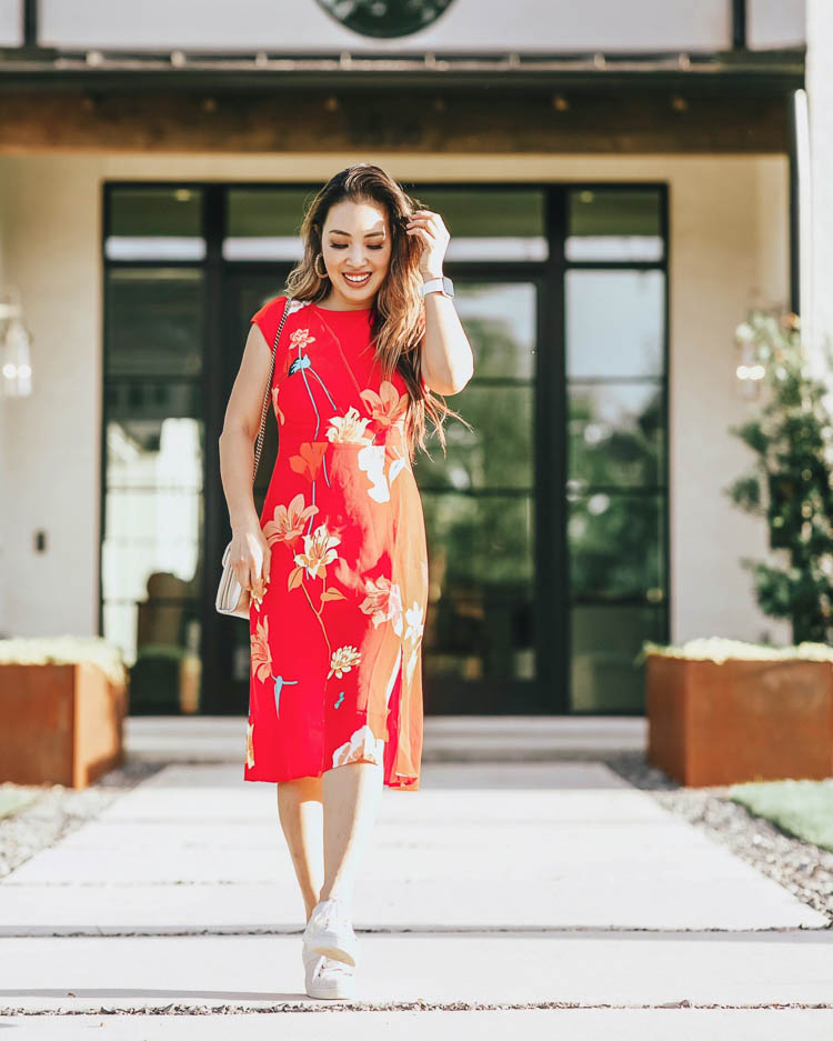 cute & little | dallas petite fashion blog | loft red floral midi dress, trask white lace-up sneakers | quarantine work office spring outfit | The Enneagram Test by popular Dallas lifestyle blog, Cute and Little: image of a woman wearing a Loft LILY CAP SLEEVE MIDI DRESS, Zappos Trask Lindsey sneakers, Target Fitbit Versa Lite Smartwatch, BaubleBar PITTI PISA HOOP EARRINGS, Gucci GG Marmont Matelassé Mini Bag, Sephora HUDA BEAUTY Liquid Matte Lipstick, and Ulta Kiss  Lash Couture Faux Mink, Soir.