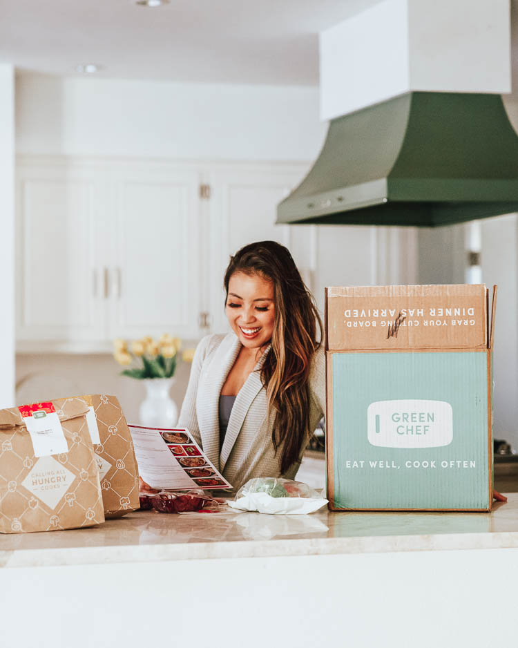comparing 5 different home meal delivery kits | best meal delivery kit | Meal Delivery Service Reviews by popular Dallas lifestyle blog, Cute and Little: image of a woman standing in her kitchen next to a Green Chef box. 
