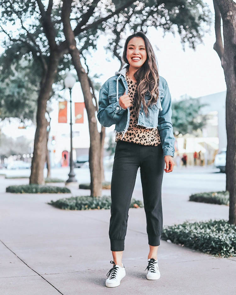 cute & little | dallas petite fashion blog | how to style joggers outfit ideas | leopard sweater, denim hoodie jacket, golden goose sneakers dupes | How to Style Joggers by popular Dallas petite fashion blog, Cute and Little: image of a woman wearing a hooded denim jacket, leopard sweater, Lululemon Align Jogger Crop 23".