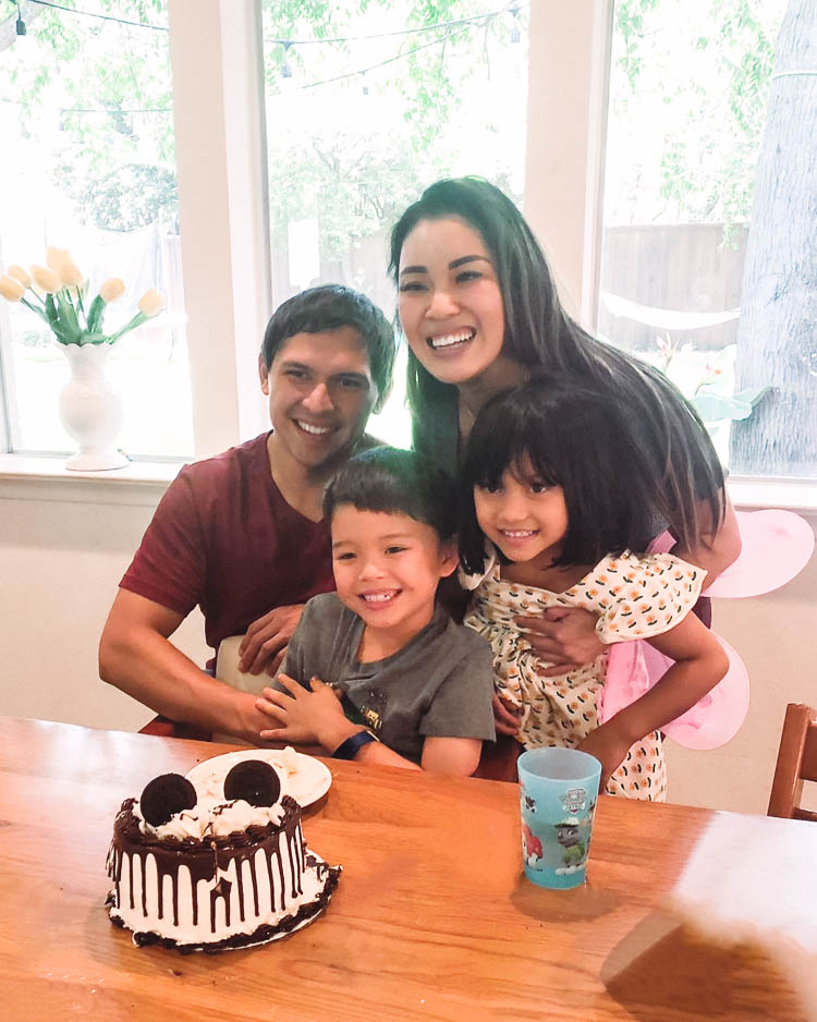 cute & little | dallas fashion lifestyle blog | quarantine social distancing kids birthday party ideas | Birthday Party Ideas for Kids by popular Dallas lifestyle blog, Cute and Little: image of a family sitting in front of a Baskin Robins ice cream cake. 