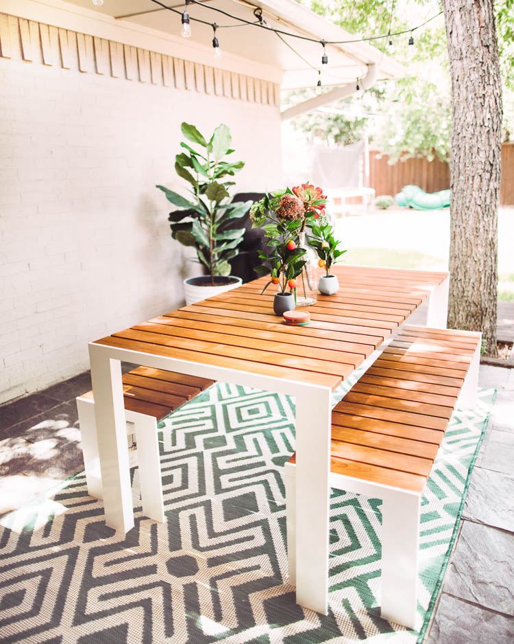 cute & little | dallas lifestyle blog | mid-century modern outdoor patio decorating ideas | egg chair | Mid Century Modern Backyard by popular Dallas lifestyle blog, Cute and Little: image of a Design Within Reach Deneb Table with a Design Within Reach Deneb Bench that's next to a World Market Faux Fiddle-Leaf Fig Plant and Amazon LA JOLIE MUSE Tall Planters.