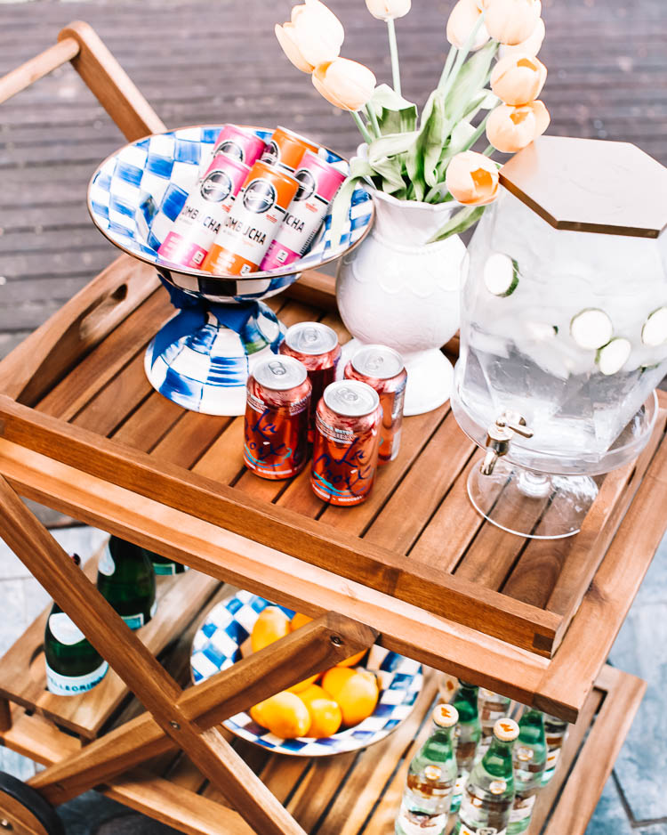 cute & little | mackenzie childs royal check outdoor patio dining table decor | how to setup bar cart | Patio Table by popular Dallas life and style blog, Cute and Little: image of a Wayfair Pinecrest Bar Serving Cart, Mackenzie Childs Royal Check Compote, and Mackenzie Childs Royal Check Breakfast Bowl.