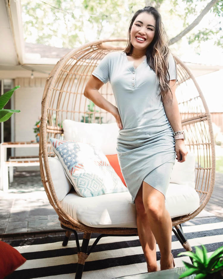 cute & little | dallas lifestyle blog | mid-century modern outdoor patio decorating ideas | egg chair | Mid Century Modern Backyard by popular Dallas lifestyle blog, Cute and Little: image of a woman wearing a BTFBM Women’s 2020 Casual V Neck Short Sleeve Ruched Bodycon T Shirt Short Mini Dress and Sequin FIGARO LINK CHOKER NECKLACE and standing next to a Target Southport Patio Egg Chair that's on a Boutique Rugs Douds Area Rug.