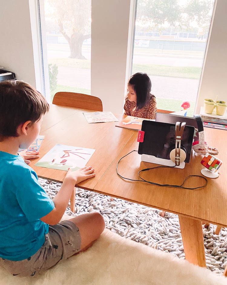 cute & little | dallas mom lifestyle blog | back to school organization homeschooling | Homeschool Organization by popular Dallas motherhood blog, Cute and Little: image of two kids sitting at a dinning table as they do homeschool work. 