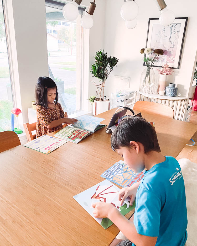 cute & little | dallas mom lifestyle blog | back to school organization homeschooling | Homeschool Organization by popular Dallas motherhood blog, Cute and Little: image of two kids sitting at a table and doing paint by stickers books. 