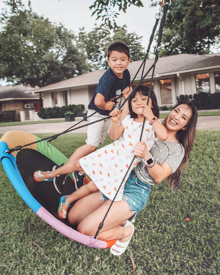 cute & little | dallas mom lifestyle blog | walmart express delivery review | Express Delivery Service by popular Dallas lifestyle blog, Cute and Little: image of a woman sitting on a Walmart Goplus 40'' Flying Saucer Tree Swing Indoor Outdoor Play Set Swing for Kids with her son and daughter. 