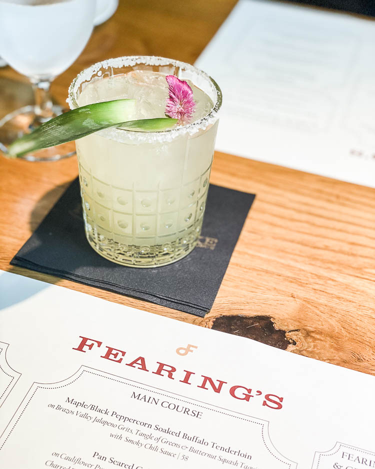 cute & little | dallas family mom travel blog | ritz-carlton dallas staycation | dean fearings restaurant magarita | rattlesnake bar | Family Staycation by popular Dallas lifestyle blog, Cute and Little: image of a Fearing's menu and a alcoholic drink. 