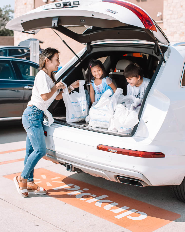 cute & little | dallas mom lifestyle blog | walmart online delivery grocery pickup review | Walmart Grocery Pickup Faq by popular Dallas lifestyle blog, Cute and Little: image of a woman loading Walmart shopping bags in to the back of her car. 