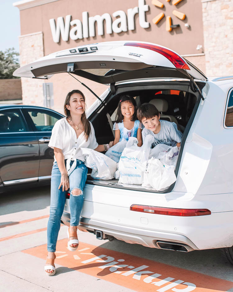 cute & little | dallas mom lifestyle blog | walmart online delivery grocery pickup review | Walmart Grocery Pickup Faq by popular Dallas lifestyle blog, Cute and Little: image of a woman and her kids sitting in the back of their car that's filled with Walmart shopping bags. 