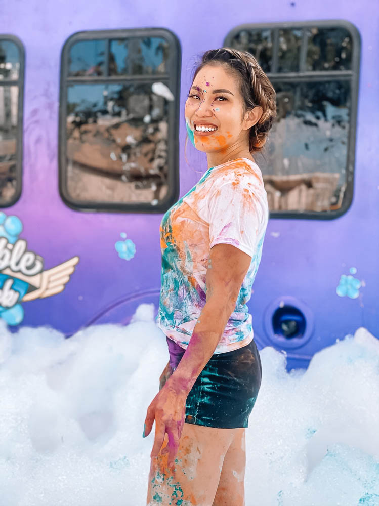 cute & little | dallas lifestyle blog | best social distancing birthday party ideas | bubble truck review | coupon discount promo code |  Bubble Truck by popular Dallas lifestyle blog, Cute and Little: image of a woman playing in foamy bubbles created by the Bubble Truck.