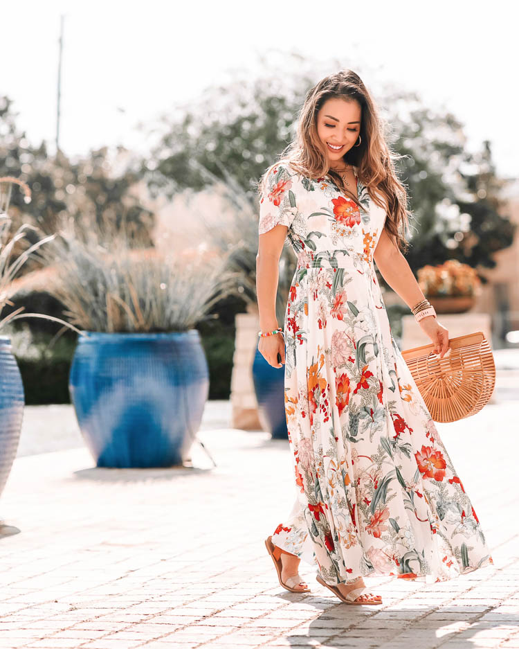 cute & little | dallas petite fashion blog | viral amazon dress | floral summer maxi vacation outfit, amazon sandals | Maxi Dress by popular Dallas petite fashion blog, Cute and Little: image of a woman walking outside by large plants in blue ceramic pots and wearing a Amazon VintageClothing Women's Floral Maxi Dresses Boho Button Up Split Beach Party Dress, Amazon DREAM PAIRS Women's Cute Open Toes One Band Ankle Strap Flexible Summer Flat Sandals, Amazon Miuco Womens Bamboo Handbag Handmade Large Tote Bag, Sequin pearl initial necklace, Gucci sunglasses, and a J.Crew Mini tube hoop earrings in matte gold.