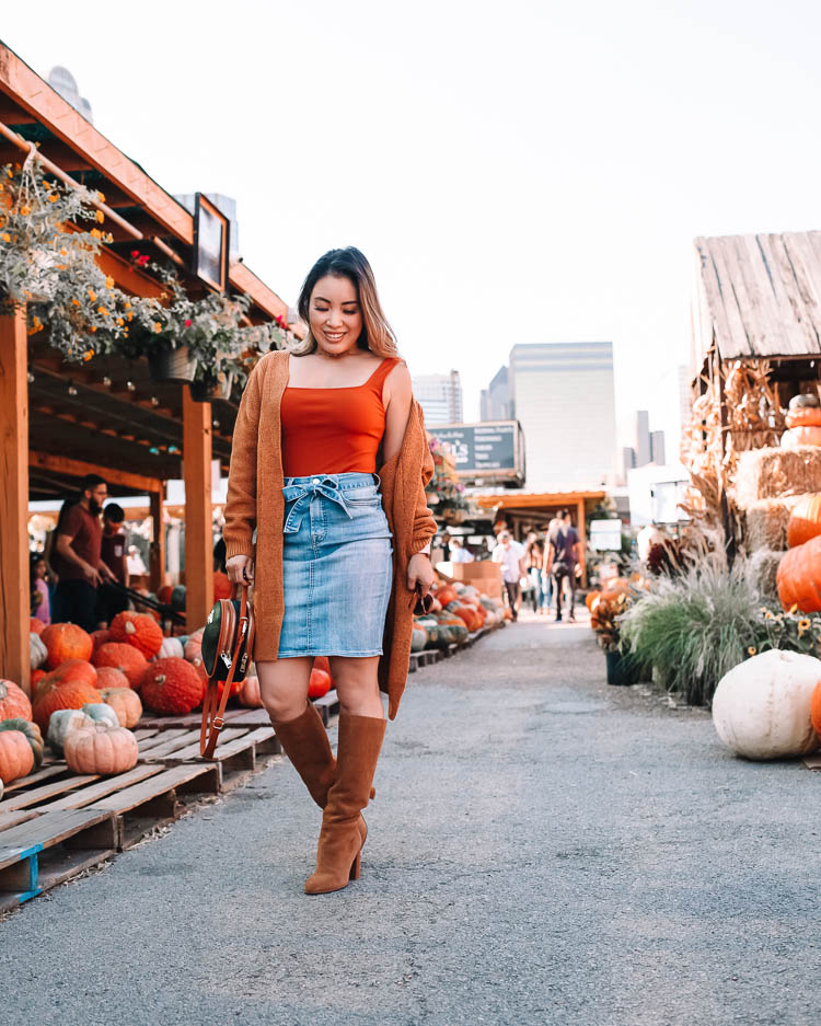 cute & little | dallas petite fashion blog | amazon chunky long cardigan, bodysuit, jen7 denim skirt, chinese laundry krafty brown suede knee high boots | dallas downtown pumpkin patch | Fall Clothing by popular Dallas petite fashion blog, Cute and Little: image of a woman visiting a pumpkin patch and wearing a Express bodysuit, Amazon futurino Women's Cable Twist School Wear Boyfriend Pocket Open Front Cardigan, JEN7 by 7 For All Mankind Denim Pencil Skirt with Belt, Zappos Chinese Laundry Krafty knee high boots, Amazon SiMYEER Small Crossbody Bags Shoulder Bag, and Sequin FIGARO LINK CHAIN BRACELET.