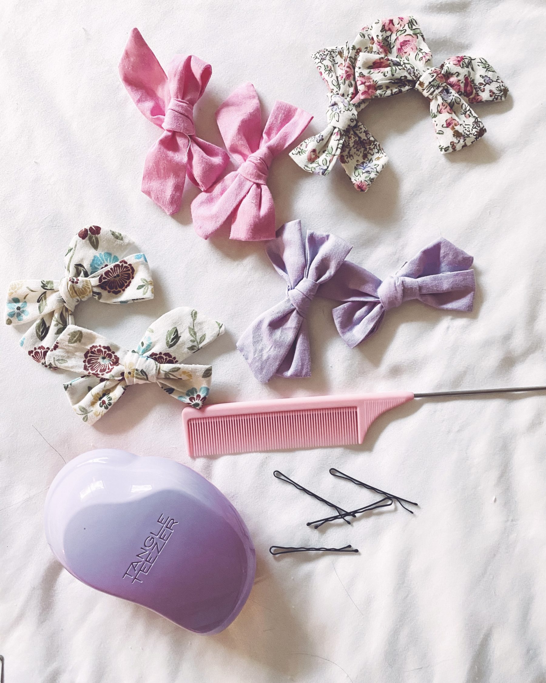 cute & little | dallas mom blog | messy pigtail space buns hairstyle school tutorial | Pigtail Buns by popular Dallas beauty blog, Cute and Little: image of rattail brush, bobby pins, Tangle Teezer brush, and Amazon CellElection hair bow clips. 