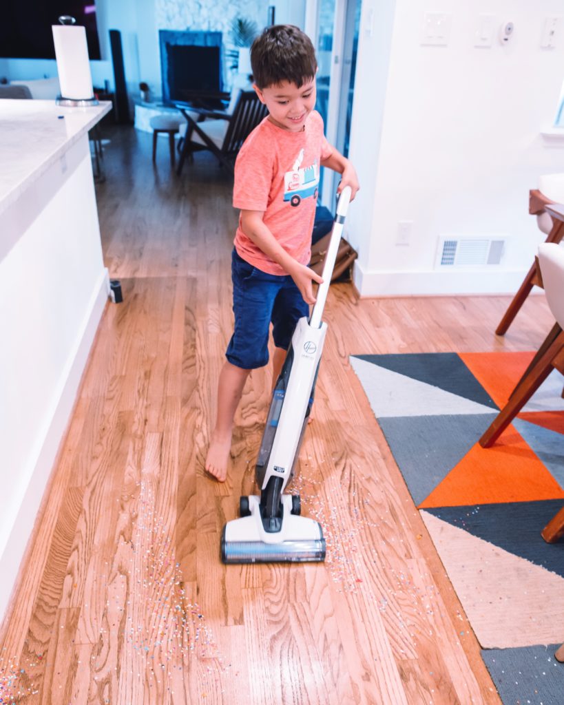 cute & little | dallas mom blog | vacuum cleaning hacks tips tricks | hoover onepwr evolve pet cordless vacuum review |Hoover Onepwr by popular Dallas lifestyle blog, Cute and Little: image of a young boy using a Hoover Onepwr evolve pet cordless vacuum.