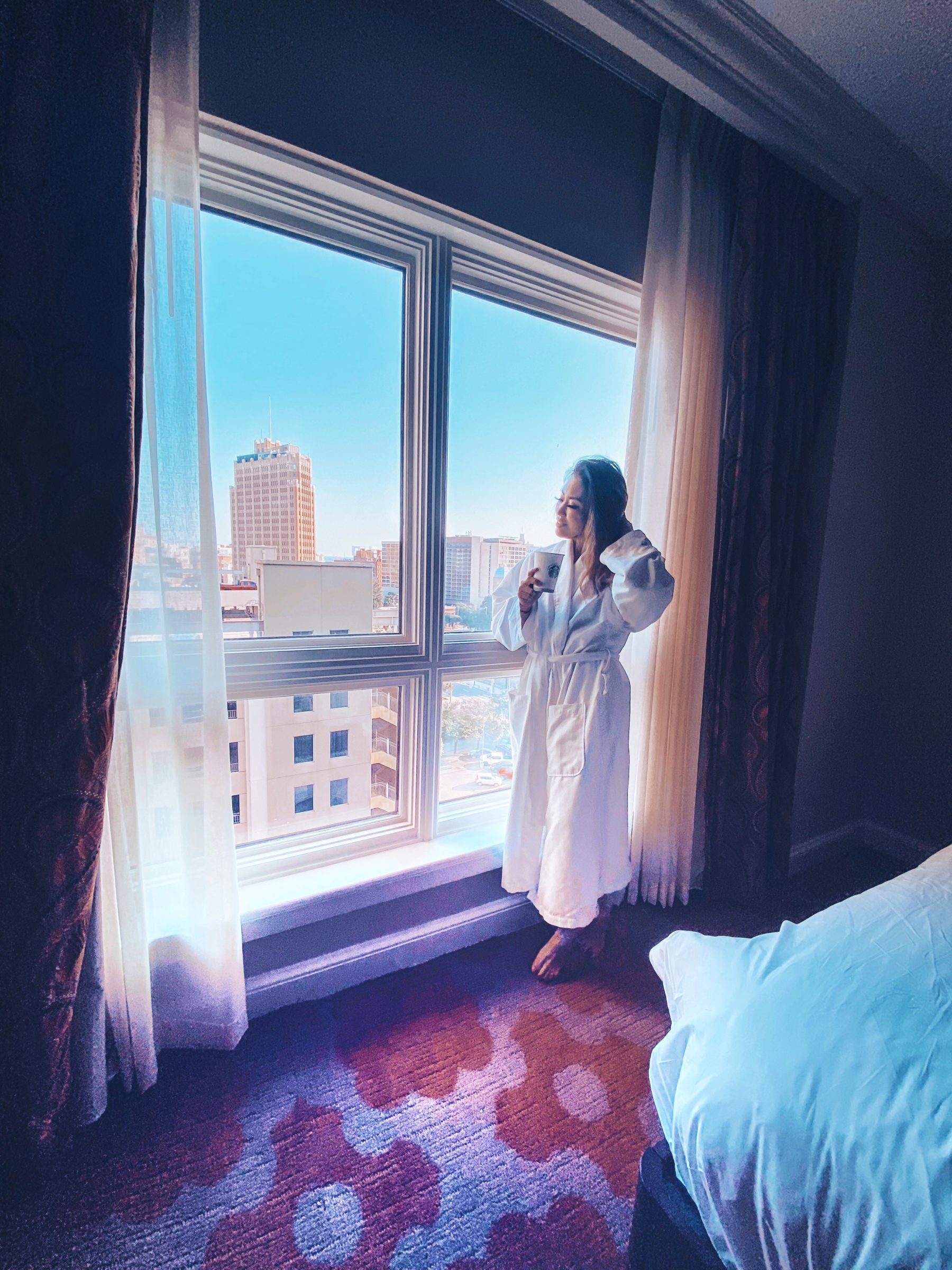 cute & little | dallas family travel blog | san antonio travel guide westin riverwalk review |San Antonio Vacation by popular Dallas travel blog, Cute and Little: image of a woman standing in her hotel room at the Westin Riverwalk hotel. 