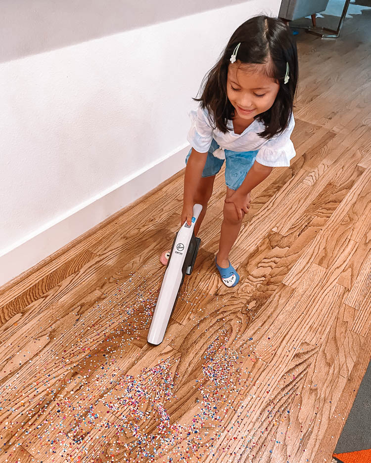 cute & little | dallas mom blog | vacuum cleaning hacks tips tricks | hoover onepwr dust chaser hand vacuum |Hoover Onepwr by popular Dallas lifestyle blog, Cute and Little: image of a young girl using a Hoover Onepwr dust chaser. 