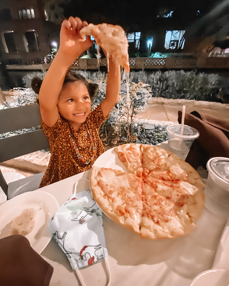 cute & little | dallas family travel blog | san antonio travel guide itinerary | westin riverwalk review |San Antonio Vacation by popular Dallas travel blog, Cute and Little: image of a girl eating pizza at Zocca Cuisin d'Italia.