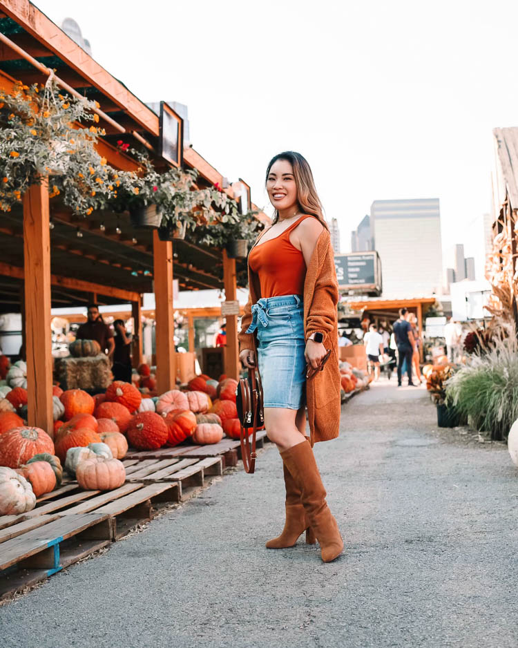 cute & little | dallas petite fashion blog | amazon chunky long cardigan, bodysuit, jen7 denim skirt, chinese laundry krafty brown suede knee high boots | dallas downtown pumpkin patch |Fall Clothing by popular Dallas petite fashion blog, Cute and Little: image of a woman visiting a pumpkin patch and wearing a Express bodysuit, Amazon futurino Women's Cable Twist School Wear Boyfriend Pocket Open Front Cardigan, JEN7 by 7 For All Mankind Denim Pencil Skirt with Belt, Zappos Chinese Laundry Krafty knee high boots, Amazon SiMYEER Small Crossbody Bags Shoulder Bag, and Sequin FIGARO LINK CHAIN BRACELET.