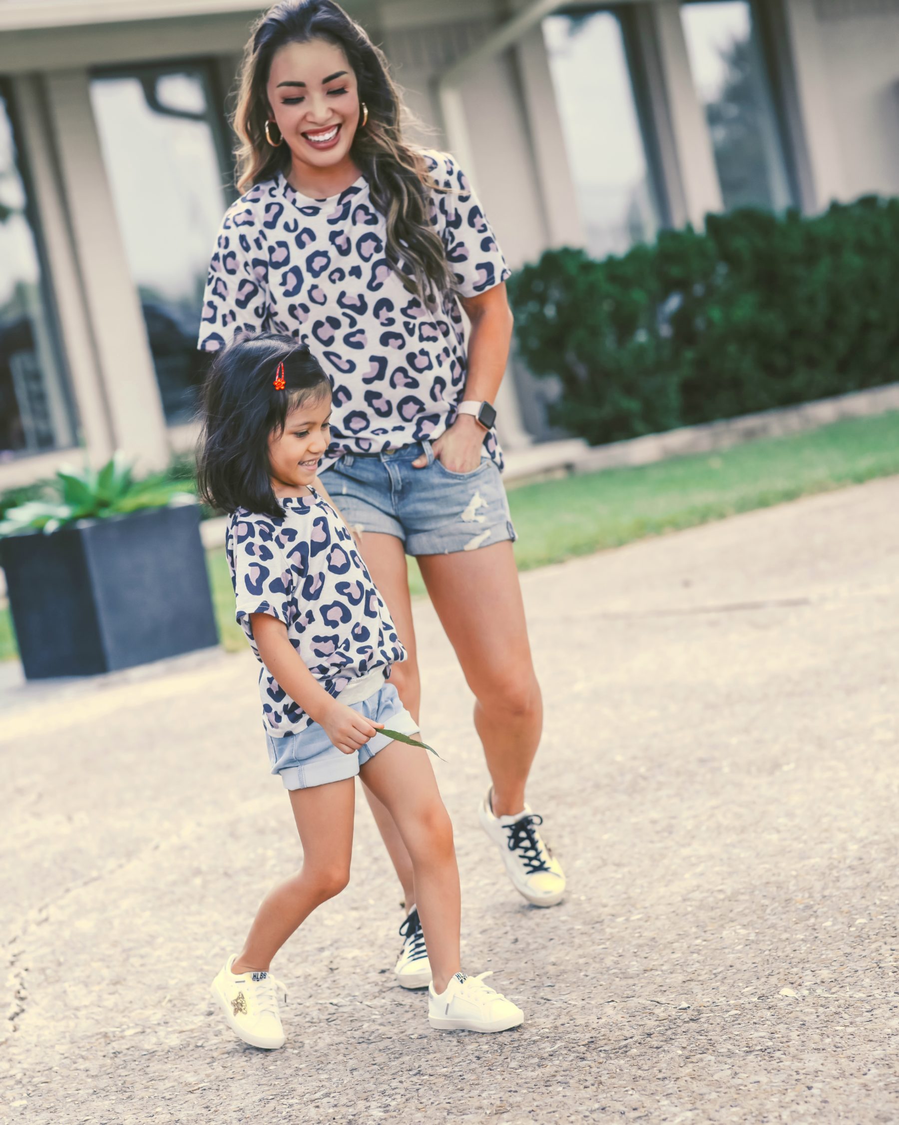 cute & little | dallas petite fashion mom blog | matching leopard shirt, jean shorts, golden goose superstar sneakers review dupes | mommy daughter matching outfits |Golden Goose Sneakers by popular Dallas petite fashion blog, Cute and Little: image of a mom and daughter wearing matching leopard print tops, Express denim shorts, GOLDEN GOOSE Superstar leather sneakers, and Amazon LanXi Girls Kids Spring Sparkle Star Bling Sequins Sneakers.
