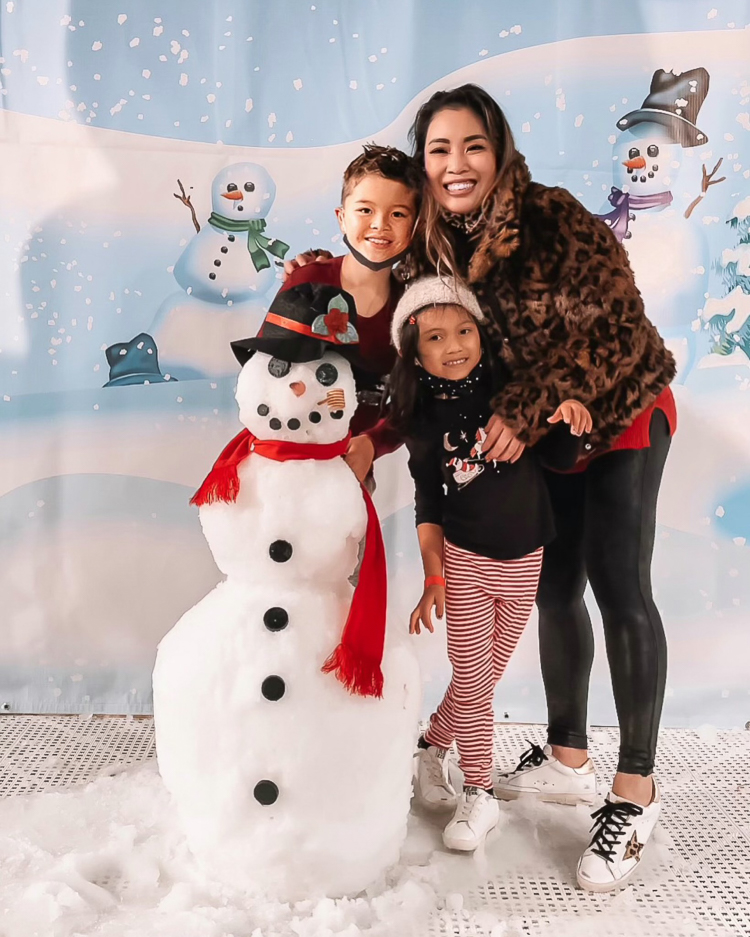 cute & little | dallas family mom blog | gaylord texas lone star christmas | build your own snowman review |Gaylord Texan by popular Dallas lifestyle blog, Cute and Little: image of a mom and her two kids standing next to a snowman. 