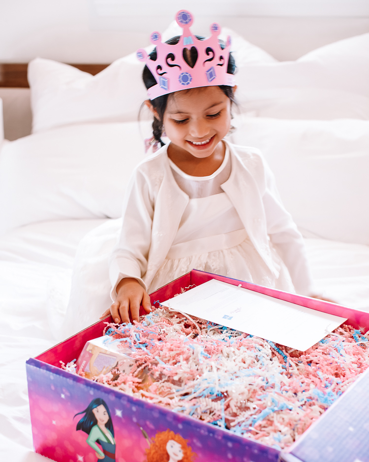 cute & little | dallas petite fashion blog | hasbro disney princess royal shimmer fashion doll unboxing review | girls holiday 2020 gift guide idea |Disney Princess Dolls by popular Dallas lifestyle blog, Cute and Little: image of a little girl opening a Disney princess dolls box. 