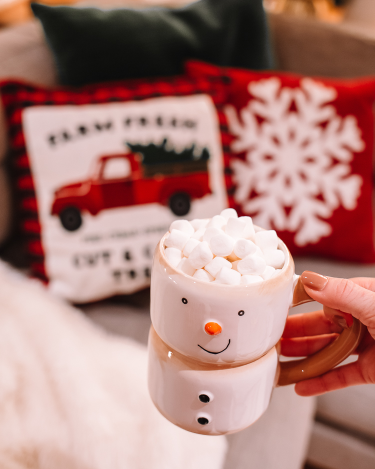 cute & little | dallas mom blog | holiday living room decor walmart |Walmart Holiday Decorations by popular Dallas life and style blog, Cute and Little: image of a woman holding a snowman mug filed with hot chocolate and mini marshmallows. 