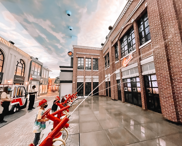 cute & little | dallas mom lifestyle blog | things to do frisco holidays 2020 | kidzania review |Things to do in Frisco TX by popular Dallas travel blog, Cute and Little: image of a boy dressed up as a firefighter at KidZania. 