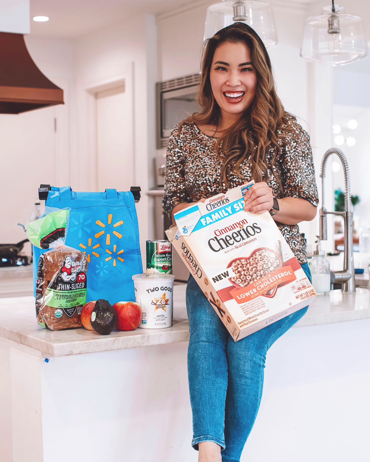 cute & little | dallas lifestyle blog | walmart kroger basket comparison | Walmart Basket Comparison by popular Dallas lifestyle blog, Cute and Little: image of a woman sitting on her kitchen counter next to a Walmart shopping bag, bread, produce, yogurt, and canned goods. 