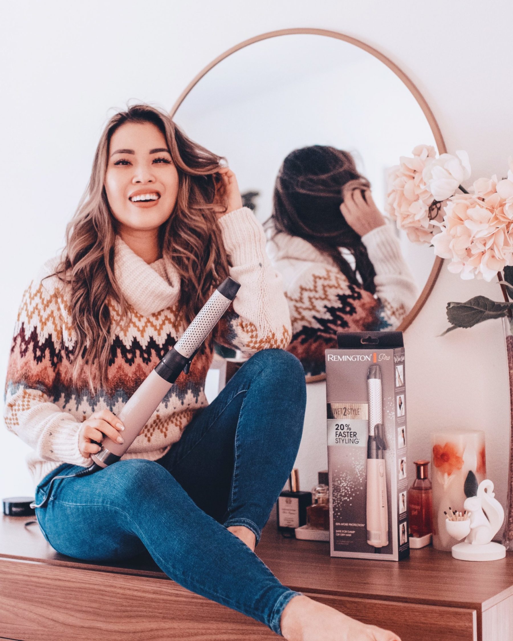 cute & little | dallas petite fashion blog | walmart beauty self care products must-have |Walmart Self Care Products by popular Dallas lifestyle blog, Cute and Little: image of a woamn sitting on her dresser and holding a Remington Wet2Style hair drying wand. 