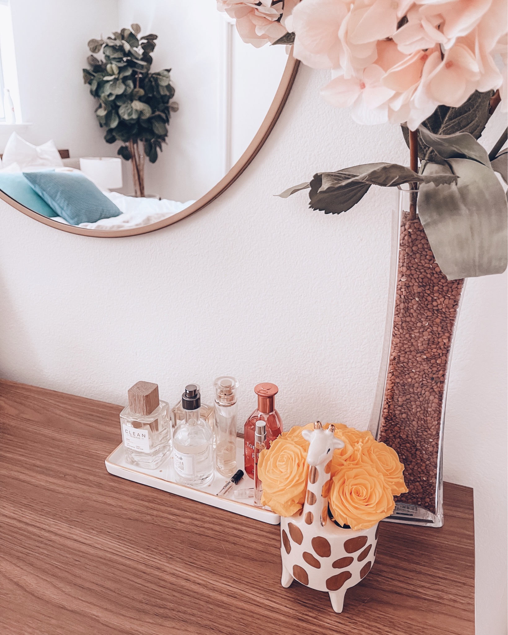 cute & little | dallas petite fashion blog | bedroom dresser decor | love always, abby flowers |Create a Home by popular Dallas life and style blog, Cute and Little: image of a round mirror, Love Always Abby preserved roses, giraffe planter, and a glass vase containing a faux hydrangea.  