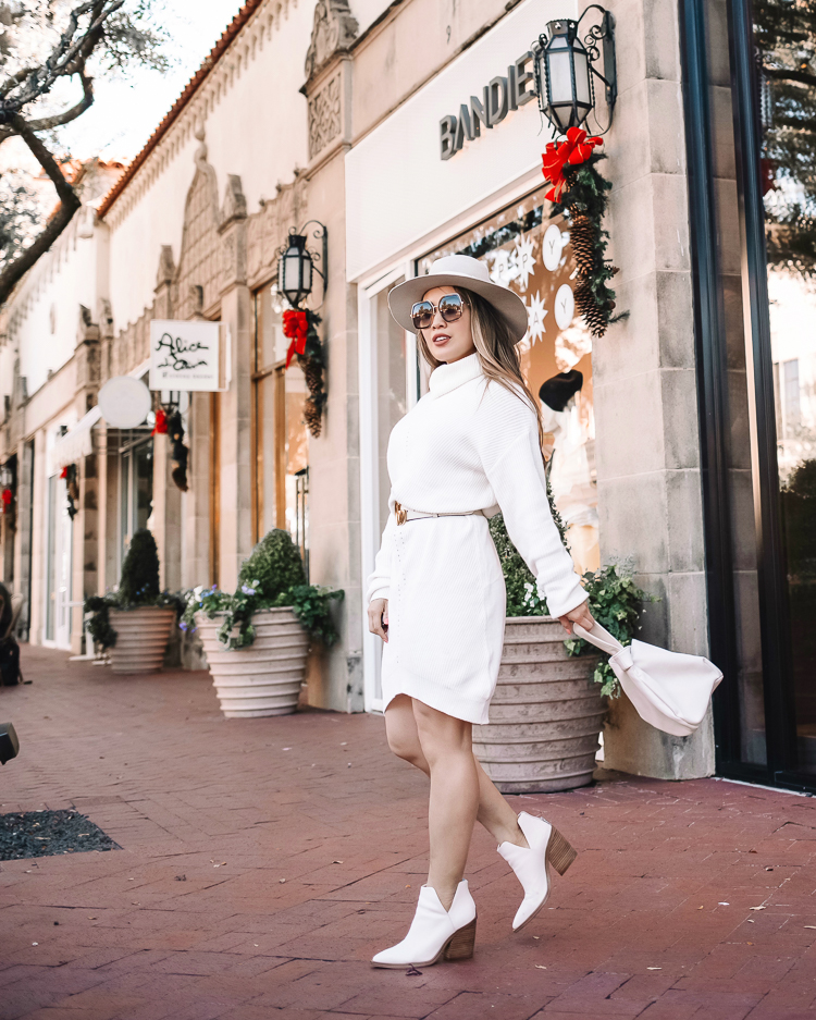 cute & little | dallas petite fashion blog | amazon winter white knit sweater dress how to style |How to Style a Sweater Dress by popular Dallas petite fashion blog, Cute and Little: image of a woman wearing a white Amazon cable knit sweater dress, white Gucci belt, white ankle boots, grey felt fedora hat and holding a white bag. 