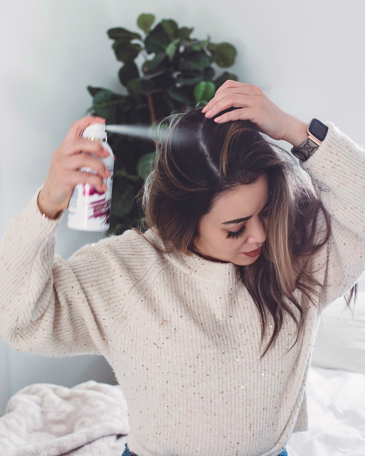 cute & little | dallas petite fashion blog | pantene waterless collection never tell dry shampoo review | how to have a good hair day tips |Good Hair Day by popular Dallas beauty blog, Cute and Little: image of a woman wearing a cream rib knit sweater and spraying Pantene Never Tell dry shampoo in her hair. 