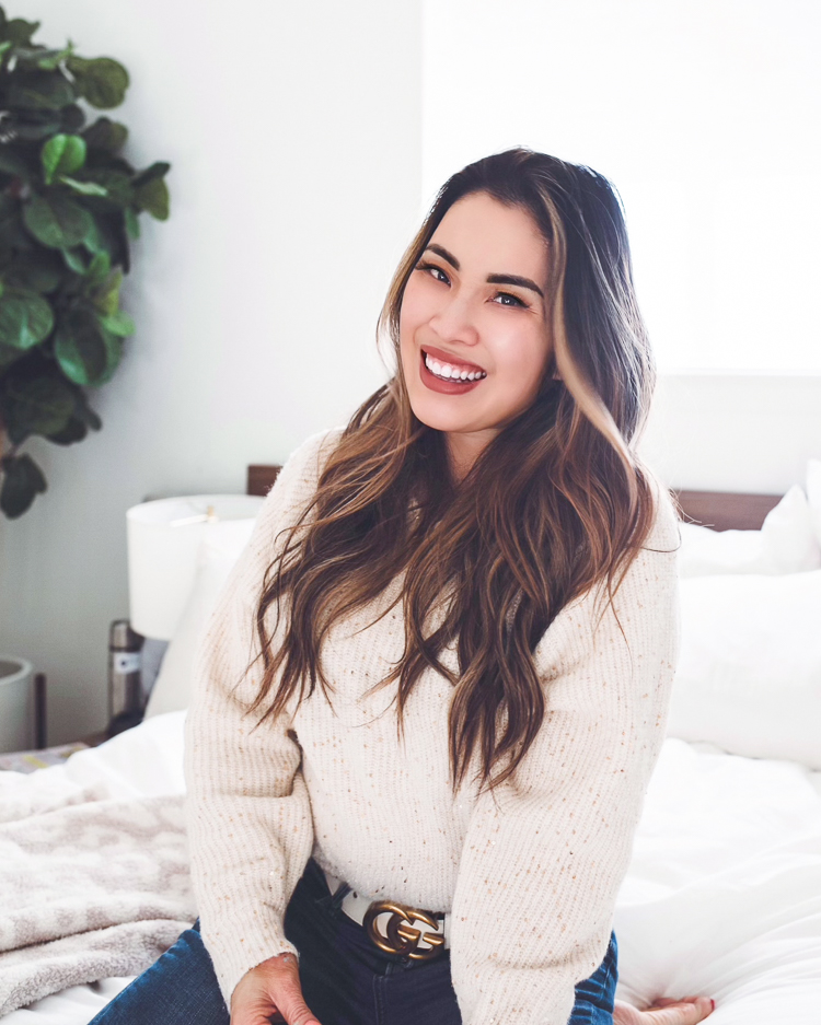 cute & little | dallas petite fashion blog | pantene waterless collection review | how to have a good hair day tips |Good Hair Day by popular Dallas beauty blog, Cute and Little: image of a woman wearing a cream rib knit sweater and sitting on her bed.