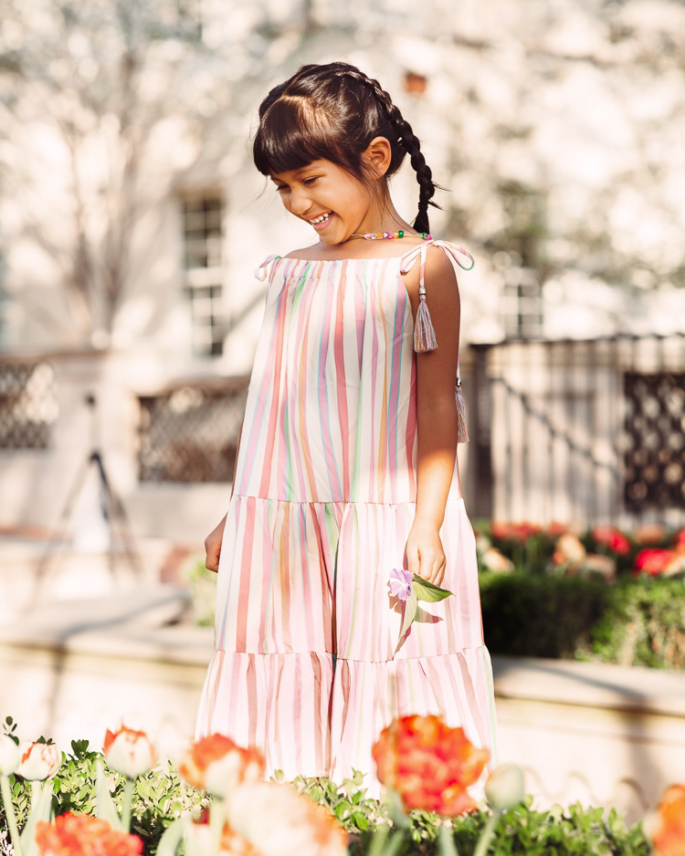 cute & little | dallas mom petite fashion blog | chicwish matching mom daughter dresses mothers day easter beach vacation photoshoot outfit |Mommy and Me Dresses by popular Dallas petite fashion blog, Cute and Little: image of a little girls wearing a Chicwish Rainbow Candy maxi dress.