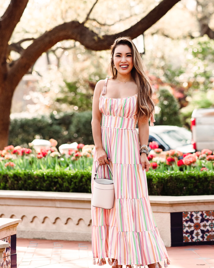 cute & little | dallas mom petite fashion blog | chicwish matching mom daughter dresses mothers day easter beach vacation photoshoot outfit |Mommy and Me Dresses by popular Dallas petite fashion blog, Cute and Little: image of a woman wearing Chicwish Rainbow Candy maxi dress and holding a Kate Spade Cameron bucket bag. 