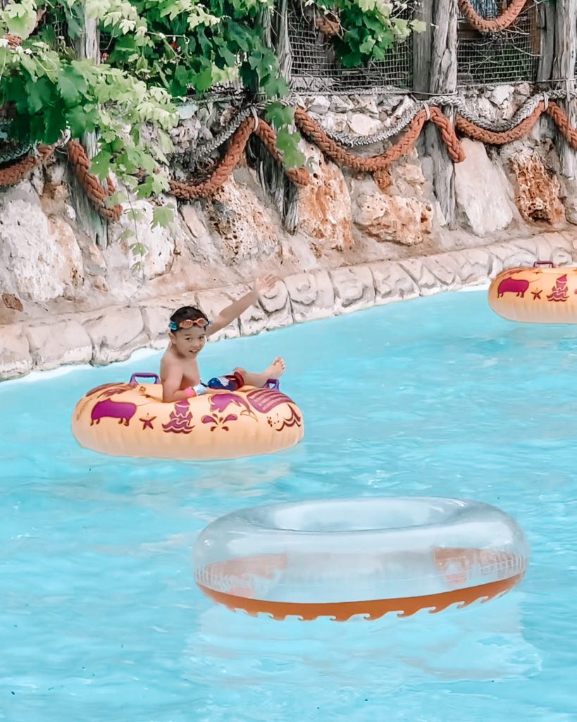 cute & little | dallas mom family travel blog | schlitterbahn new braunfels review tips | schlitterstein kristal river | Schlitterbahn Waterpark by popular Dallas travel blog, Cute and Little: image of a young boy floating in a yellow inner tube on a lazy river. 