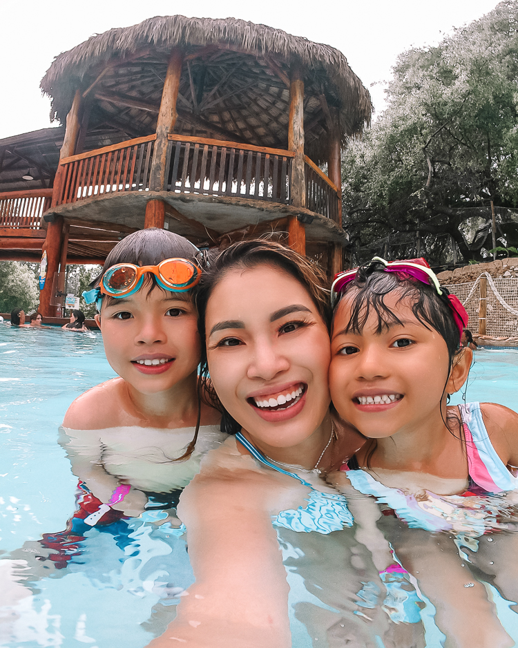 cute & little | dallas mom family travel blog | schlitterbahn new braunfels review tips | schlitterstein heated pool | Schlitterbahn Waterpark by popular Dallas travel blog, Cute and Little: image of mom and her son and daughter swimming at Schlitterbahn Waterpark. 
