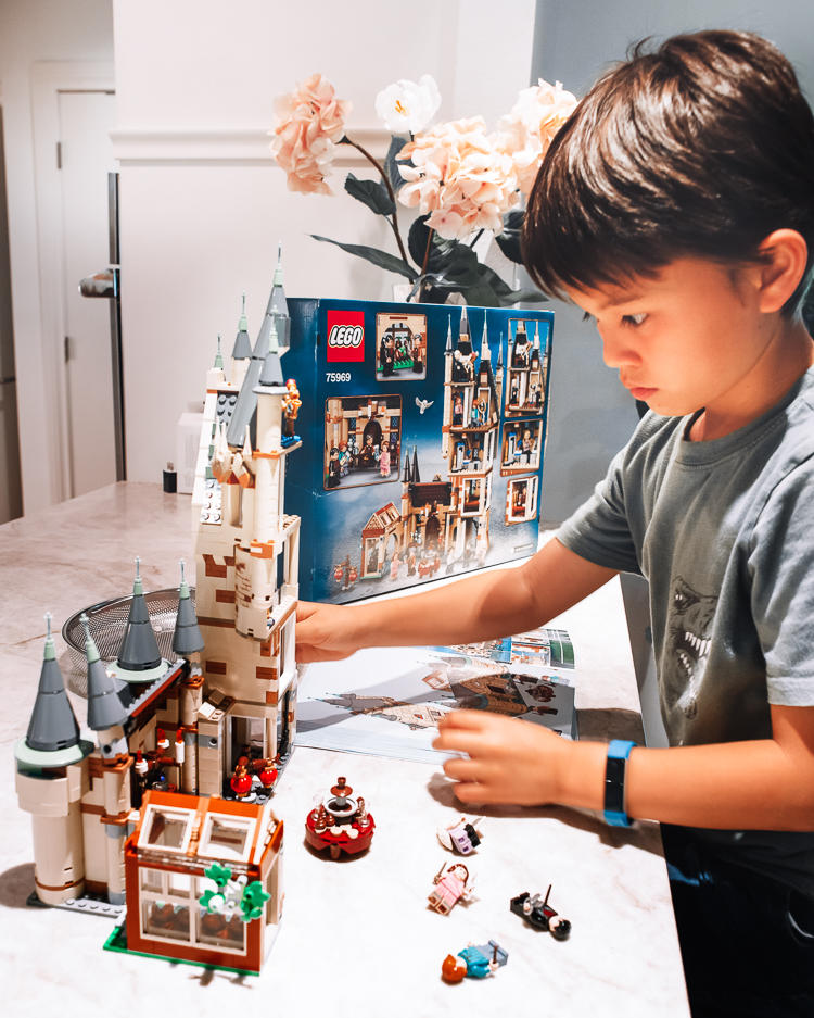 cute & little | dallas mom family travel blog | walmart pickup and delivery | summer kids' activities harry potter lego | Fun Summer Activities by popular Dallas lifestyle blog, Cute and Little: image of a young boy building a Harry Potter Lego set. 