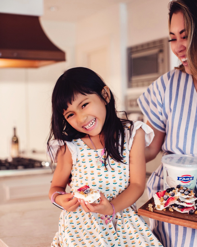 cute & little | dallas mom blog | summertime healthy snack | yogurt bark with berries | Yogurt Bark With Berries by popular Dallas lifestyle blog, Cute and Little: image of a young girl holding a piece of yogurt bark with berries. 