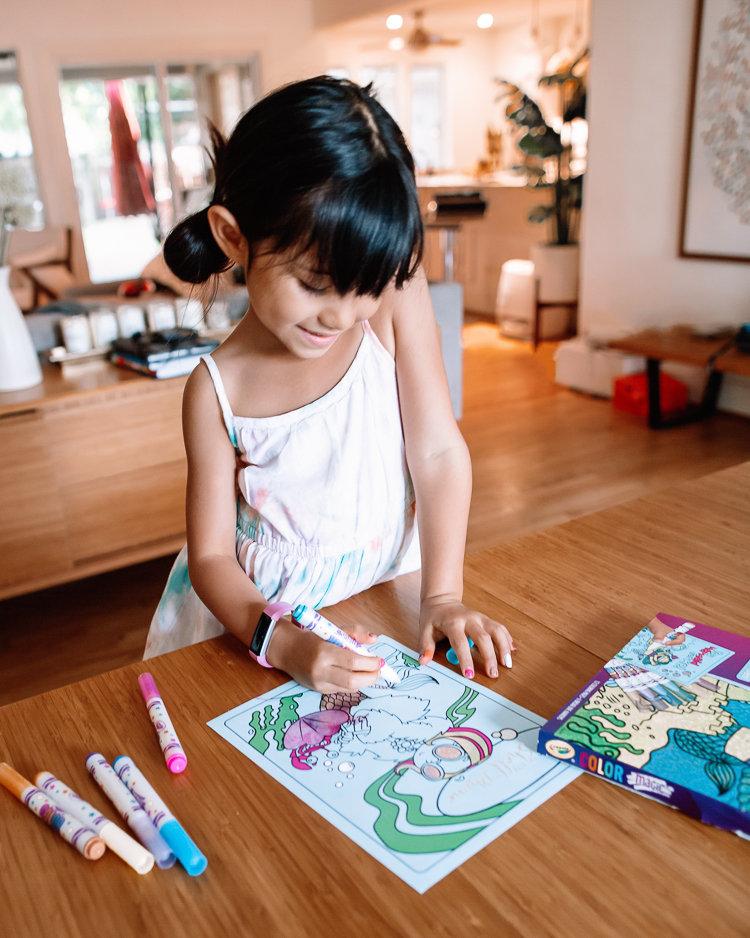 cute & little | dallas mom family travel blog | walmart pickup and delivery | summer kids' activities arts crafts | Fun Summer Activities by popular Dallas lifestyle blog, Cute and Little: image of a young girl coloring a mermaid coloring page with markers. 