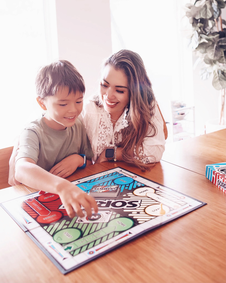 cute & little | dallas mom family travel blog | walmart pickup and delivery | summer kids' activities board games | Fun Summer Activities by popular Dallas lifestyle blog, Cute and Little: image of a mom and her young son playing Sorry. 