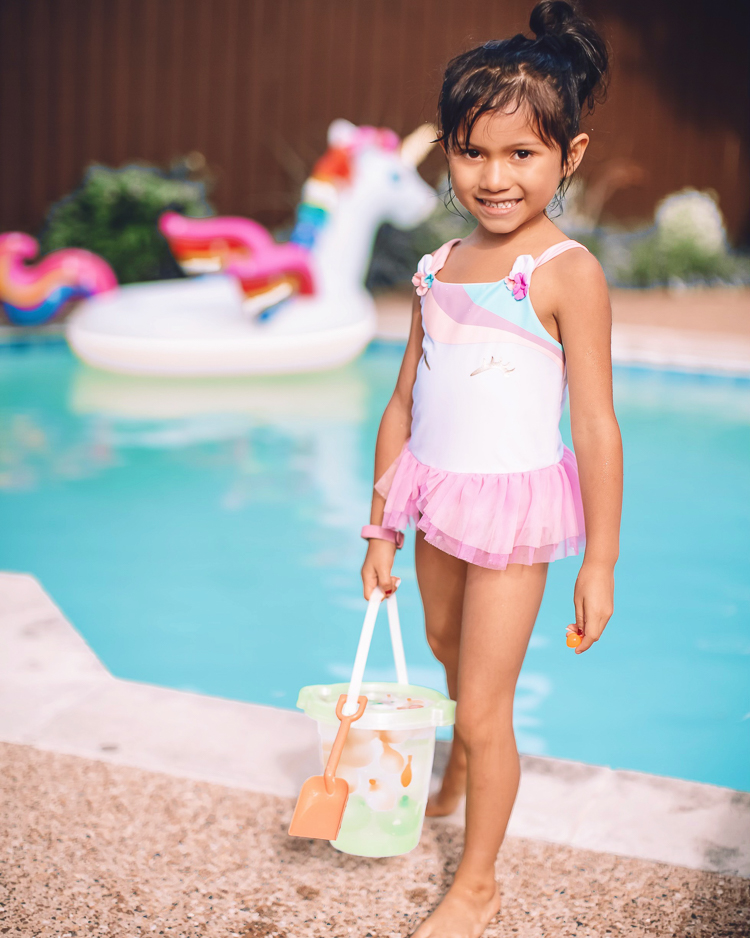 cute & little | dallas mom family travel blog | walmart plus review | backyard pool day must-haves | Pool Day by popular Dallas lifestyle blog, Cute and Little: image of a young girl wearing a pink swimsuit with a tutu and standing by a swimming pool. 