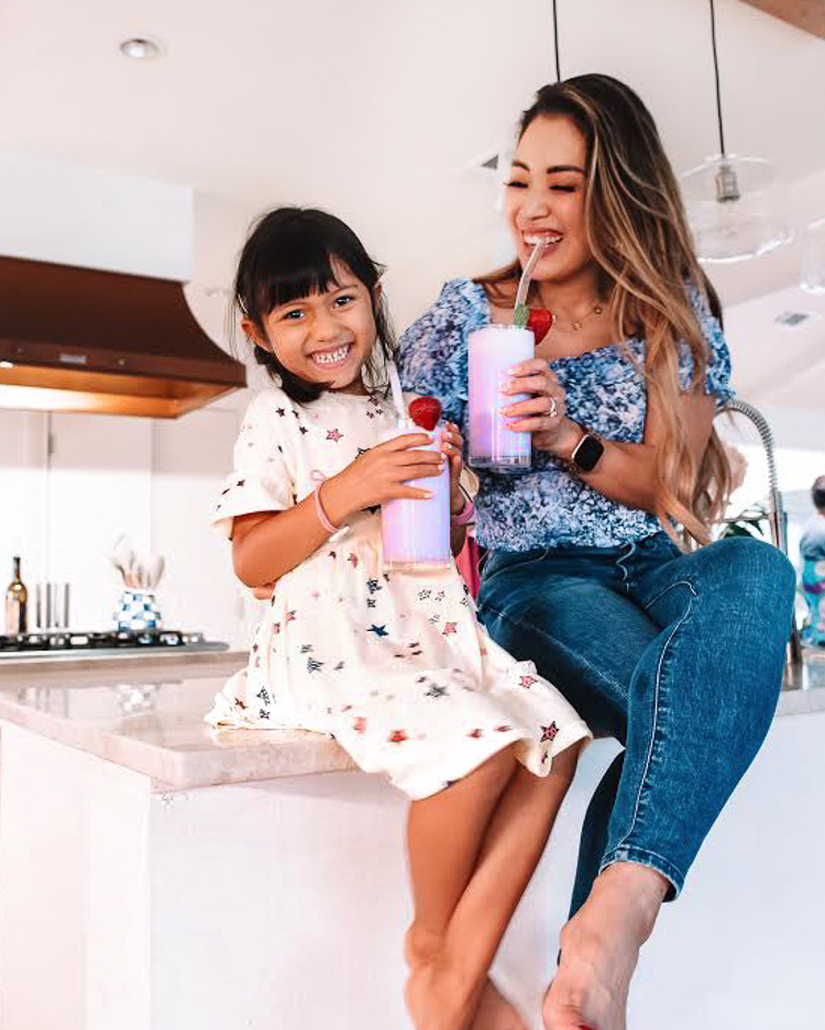 cute & little | dallas family lifestyle blogger | lactose-free taro smoothie recipe | fage bestself yogurt review | Taro Smoothie Recipe by popular Dallas lifestyle blog, Cute and Little: image of a mom and her young daughter sitting together on their kitchen counter drinking taro smoothies. 