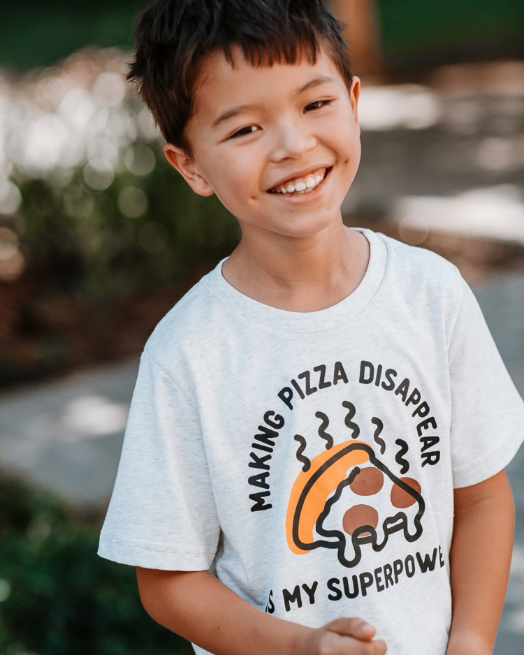 cute & little | dallas petite fashion blog | back to school outfits jcpenney |  School Routine by popular Dallas motherhood blog, Cute and Little: image of a young boy wearing a pizza graphic t-shirt, red shorts, black Nike sneakers.