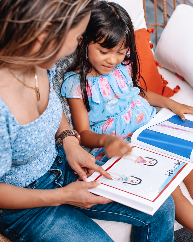 cute & little | dallas mom blogger | Artkive review | parenting de-clutter tip | how to store kids' artwork Kids Artwork by popular Dallas motherhood blog, Cute and Little: image of a mom and her young daughter looking through a Artkive book. 