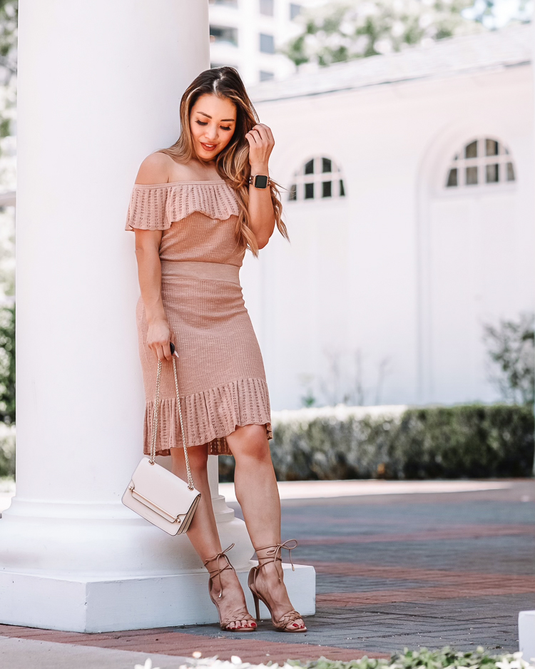 cute & little | dallas petite fashion blogger | express off shoulder sweater skirt set | summer wedding guest outfit | Matching Two Piece Skirt Set by popular Dallas petite fashion blog, Cute and Little: image of a woman wearing a Express knit skirt set with gladiator heeled sandals, and holding a cream and gold chain handbag. 