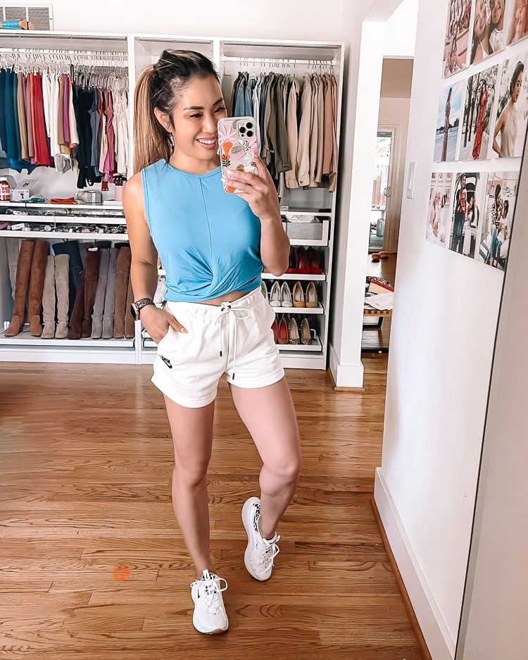 cute & little | dallas petite fashion blogger | nordstrom anniversary sale activewear loungewear outfit | Nordstrom Anniversary Sale by pouplar Dallas petite fashion blog, Cute and Little: image of a woman wearing a Nordstrom blue crop tank top, white Nike drawstring shorts, and white Nike sneakers. 