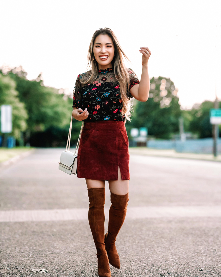 cute & little | dallas petite fashion blogger | Nordstrom Anniversary Sale workwear outfits for fall | Nordstrom Anniversary Sale by popular Dallas petite fashion blog, Cute and Little: image of a woman standing in the street and wearing a Nordstrom black floral embroidered blouse, brown suede skirt, and brown suede over the knee boots. 