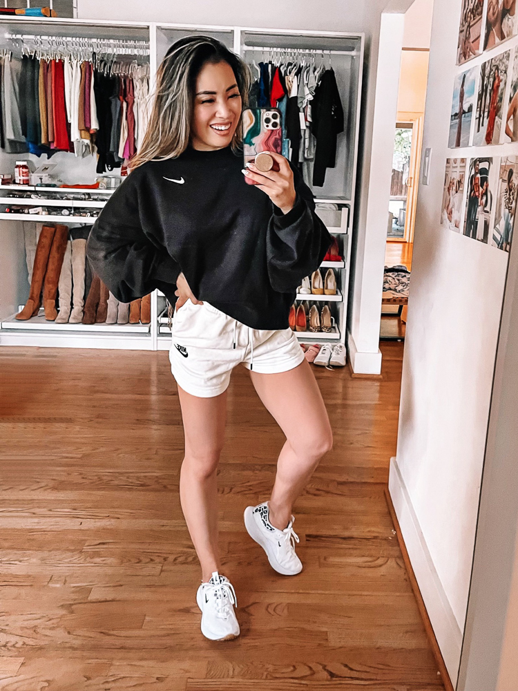 cute & little | dallas petite fashion blogger | nordstrom anniversary sale activewear workout outfits | spanx nike | Nordstrom Anniversary Sale by pouplar Dallas petite fashion blog, Cute and Little: image of a woman wearing a Nordstrom black Nike sweatshirt, white Nike shorts, and white Nike sneakers. 